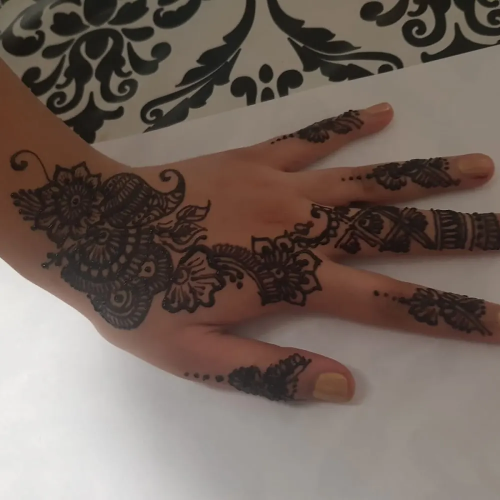Detailed mehendi pattern on the back of a hand